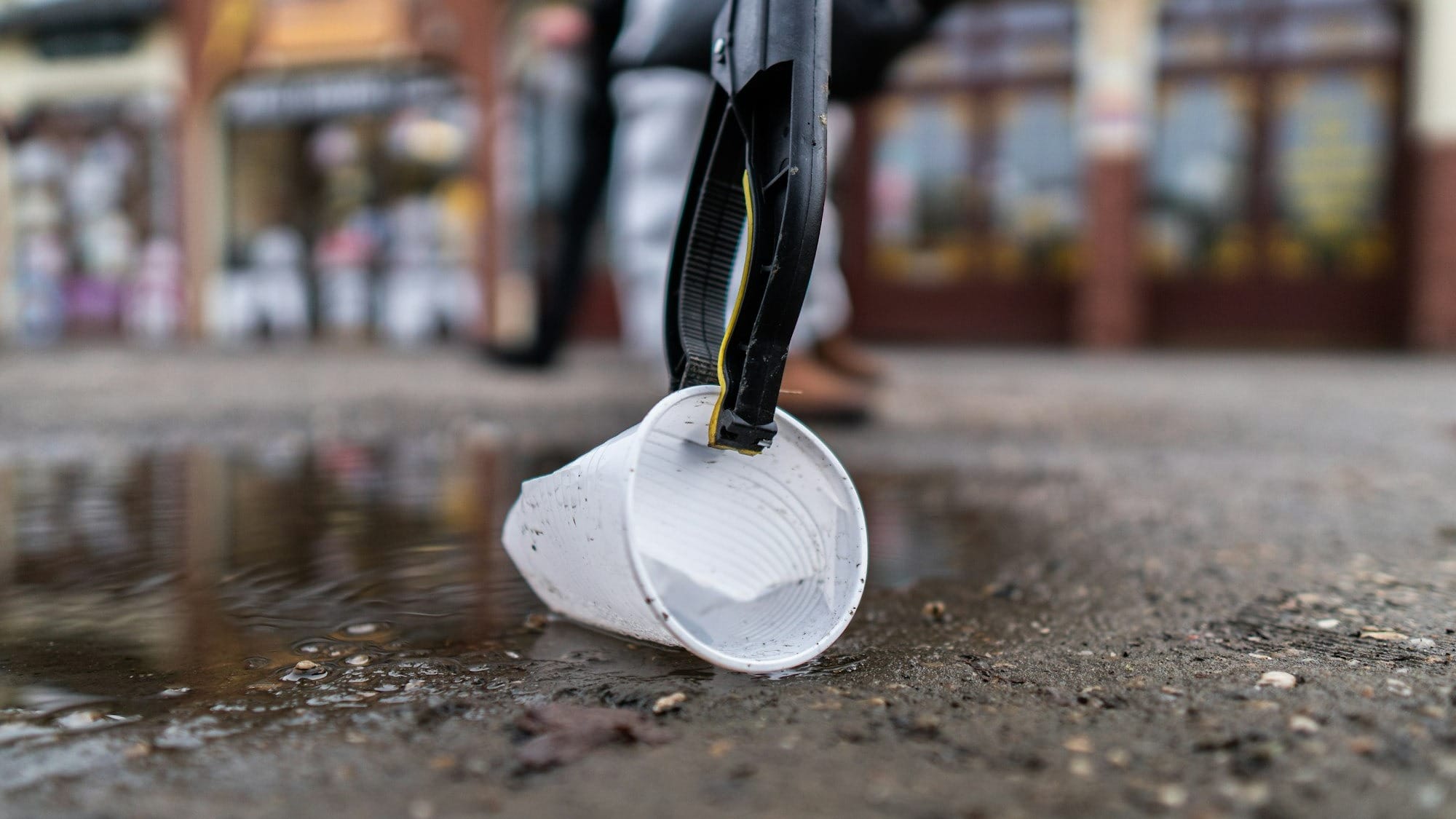 white plastic bucket on wet ground